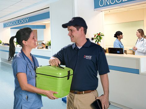 MNX courier handing insulated package to doctor