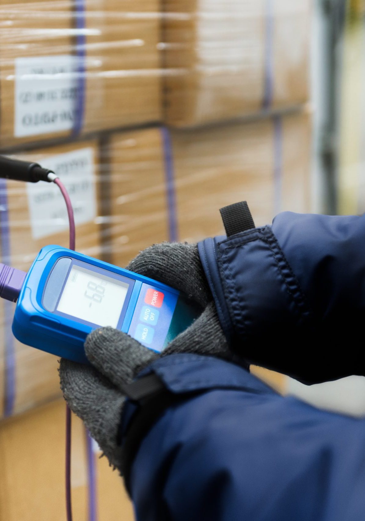 Hand of worker using thermometer